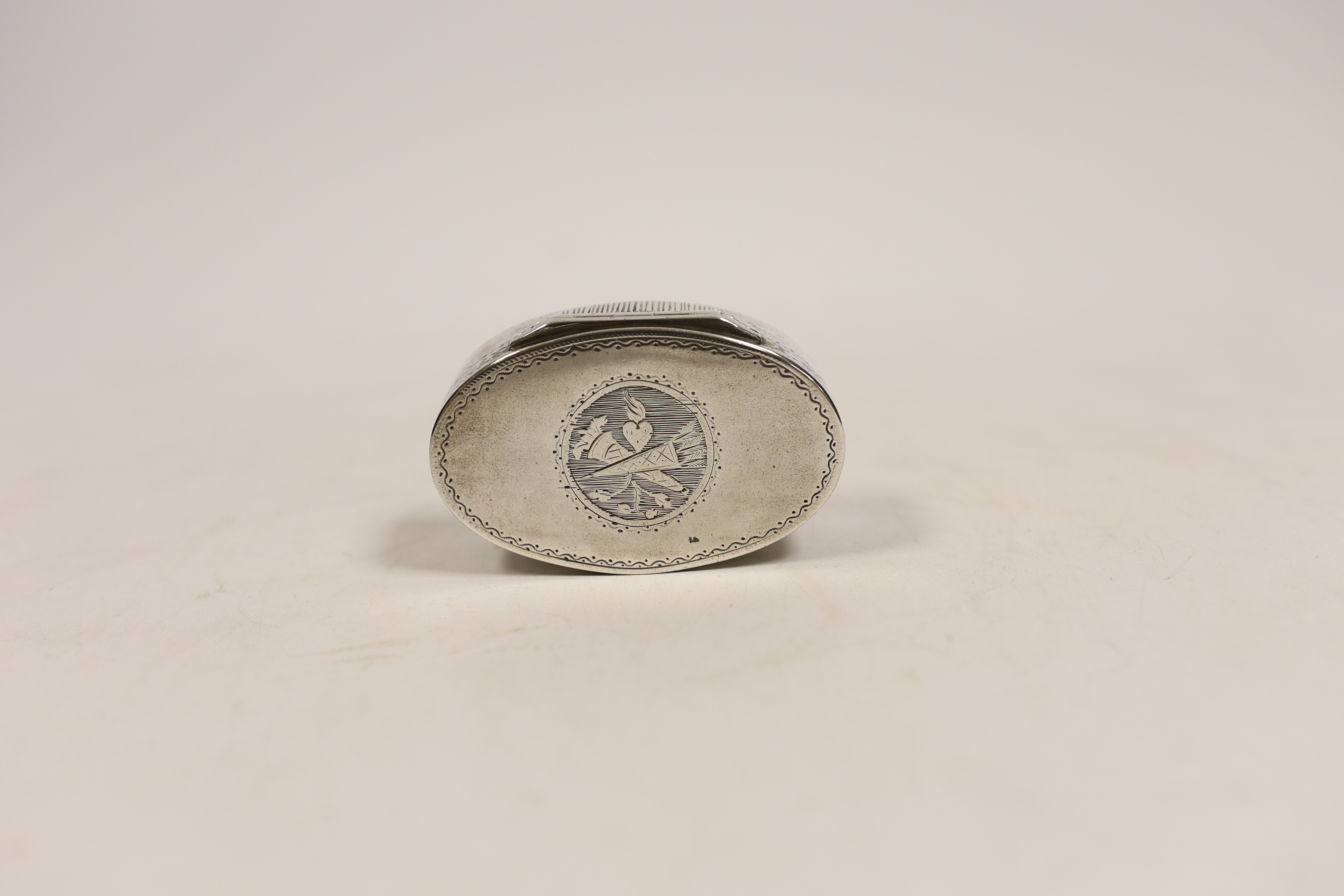 An early 19th century French engraved 800 standard white metal oval snuff box/vesta case, 69mm.